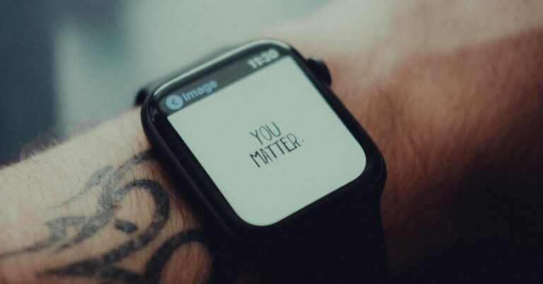 Close-up of a smartwatch displaying 'You Matter' with a tattooed arm in view.