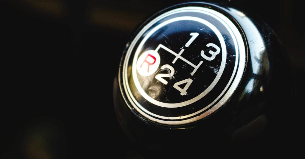 Detailed view of a manual gear shift knob inside a vehicle, focusing on the gear pattern.