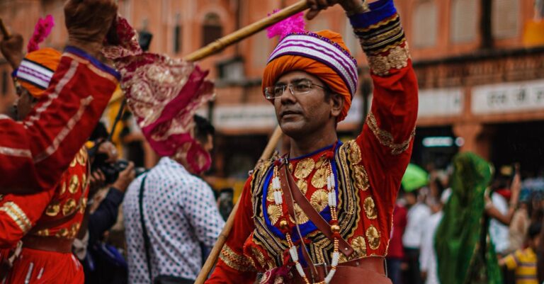 Colorful traditional dance during a lively Indian festival parade outdoors.