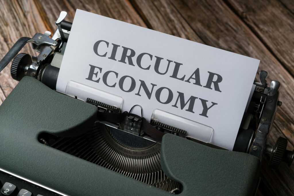 Close-up of a typewriter with 'Circular Economy' paper, suggesting sustainability.
