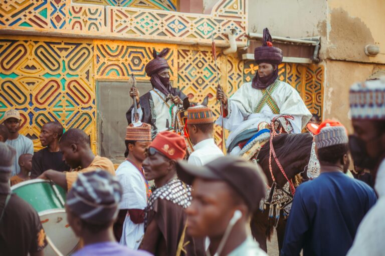 Vibrant street festival in Africa showcasing traditional attire and architecture.